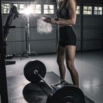 Woman training with a barbell at the gym