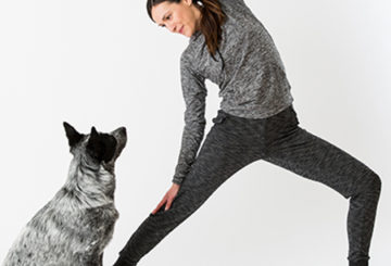 Yoga Teacher Adriene Mishler doing yoga and her dog watching her